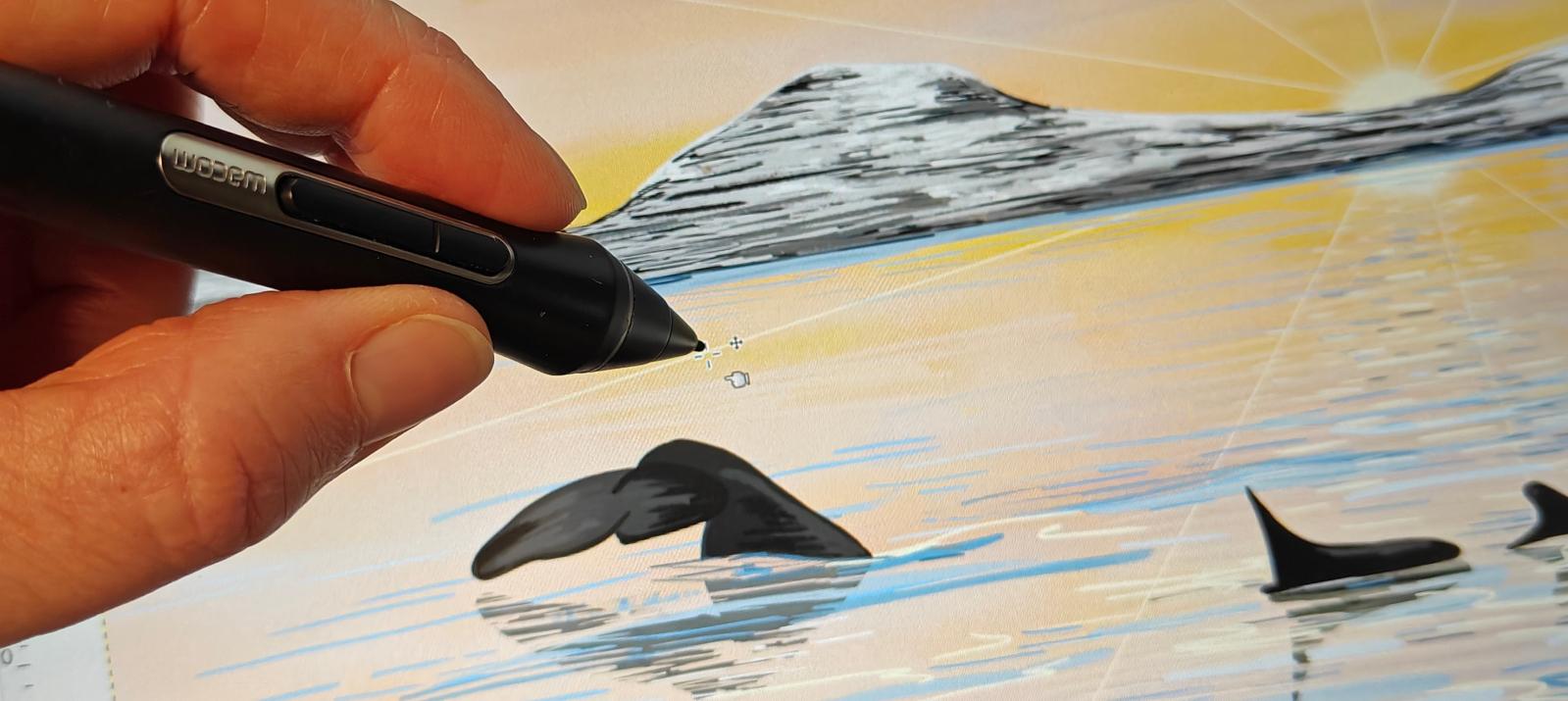 Artist drawing the Calm Spring whale safari illustration on a Wacom tablet, showing a humpback fluke and two orca fins in a golden fjord. Aurealis Creatief.